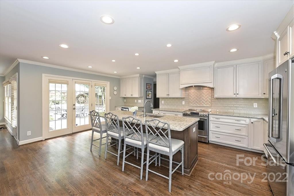 3100 Mountainbrook Road Charlotte, NC 28210 - Photo 23 of 48 a kitchen with stainless steel appliances granite countertop a table chairs sink refrigerator and cabinets