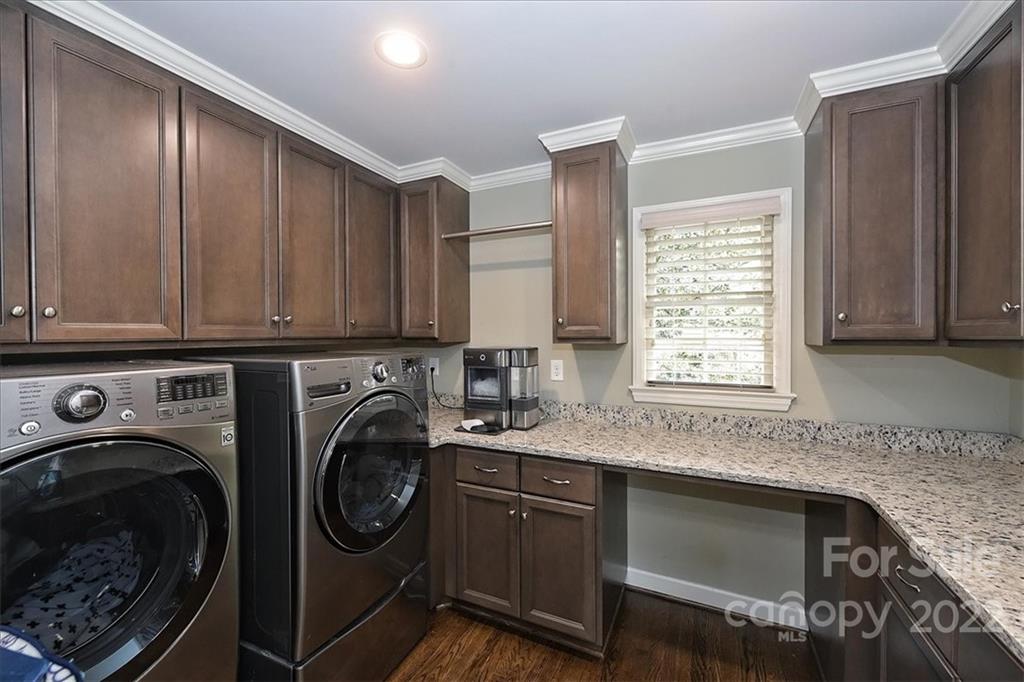 3100 Mountainbrook Road Charlotte, NC 28210 - Photo 28 of 48 a kitchen with stainless steel appliances granite countertop a sink a washer and dryer with cabinets
