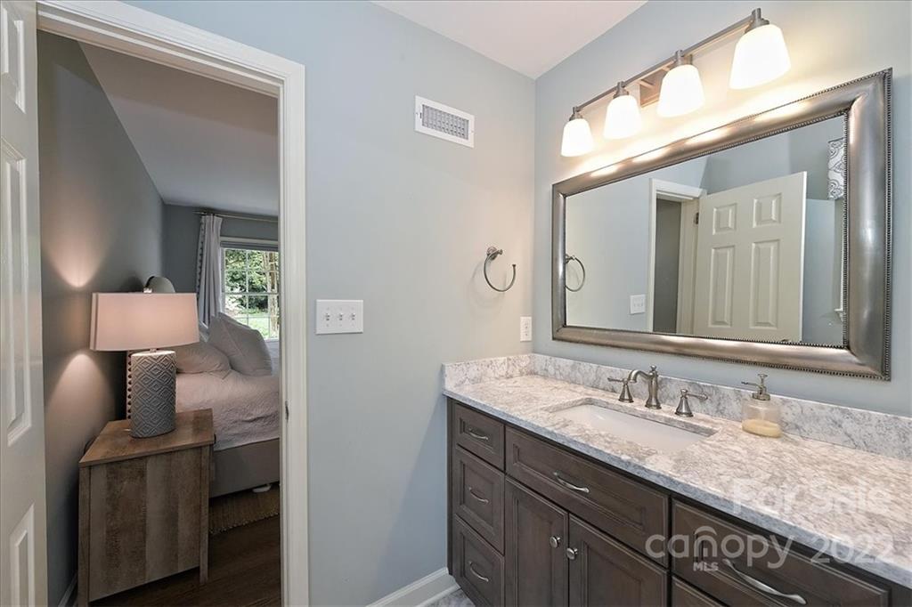3100 Mountainbrook Road Charlotte, NC 28210 - Photo 31 of 48 a en suite bathroom with a granite countertop sink and a mirror