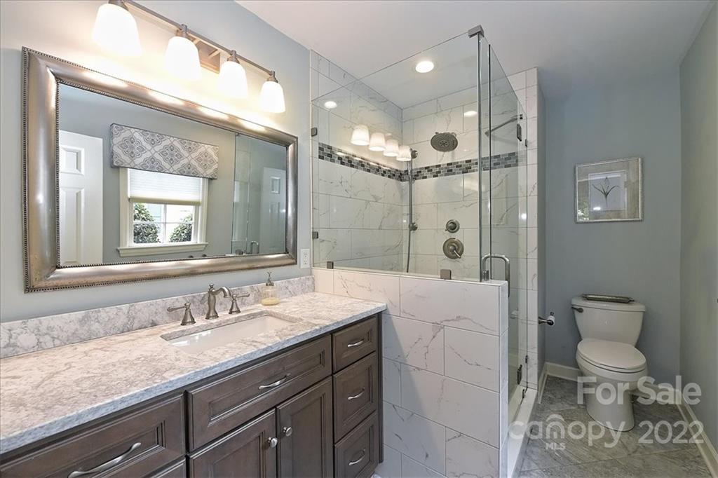 3100 Mountainbrook Road Charlotte, NC 28210 - Photo 32 of 48 a spacious bathroom with a granite countertop sink a toilet a mirror and shower