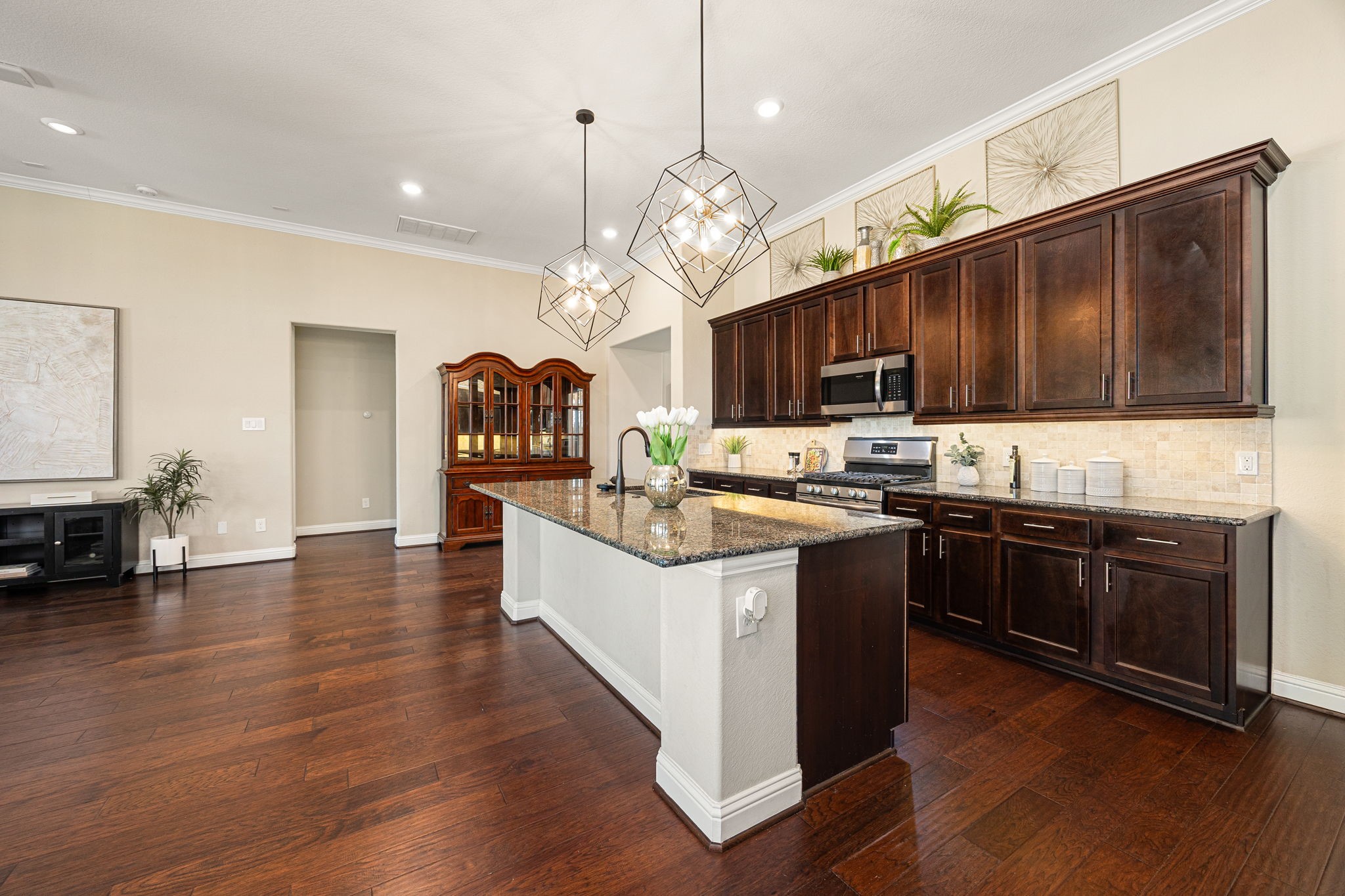 4225 Grand Oaks Wind Spring, TX 77386 - Photo 12 of 40 a large kitchen with stainless steel appliances wooden floors and a view of living room