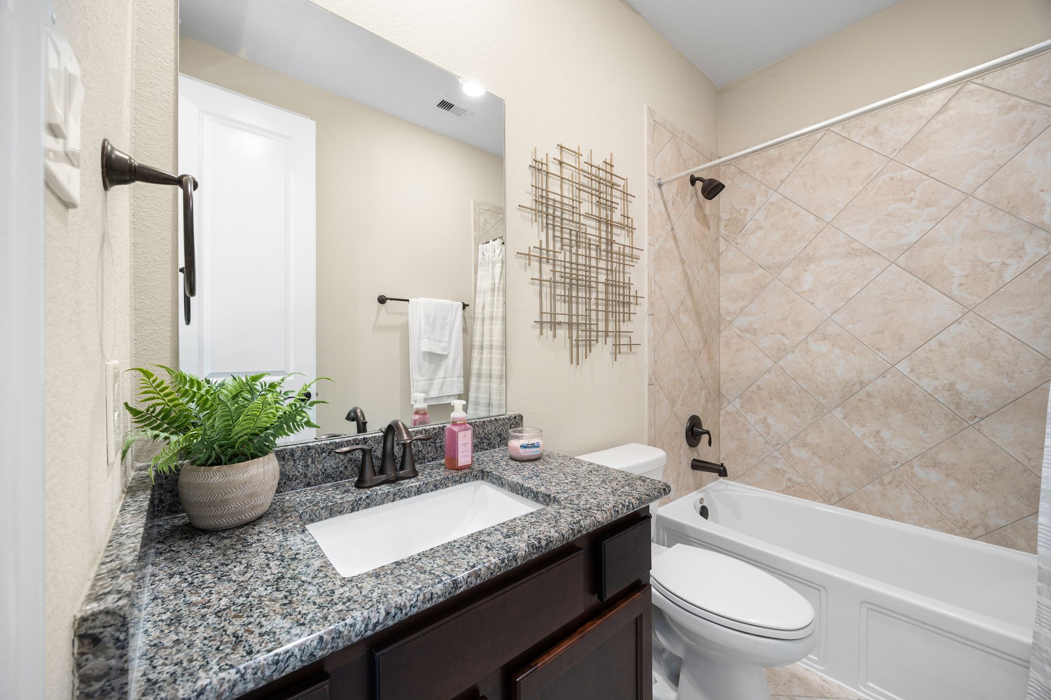 4225 Grand Oaks Wind Spring, TX 77386 - Photo 25 of 40 a bathroom with a granite countertop sink a toilet and shower