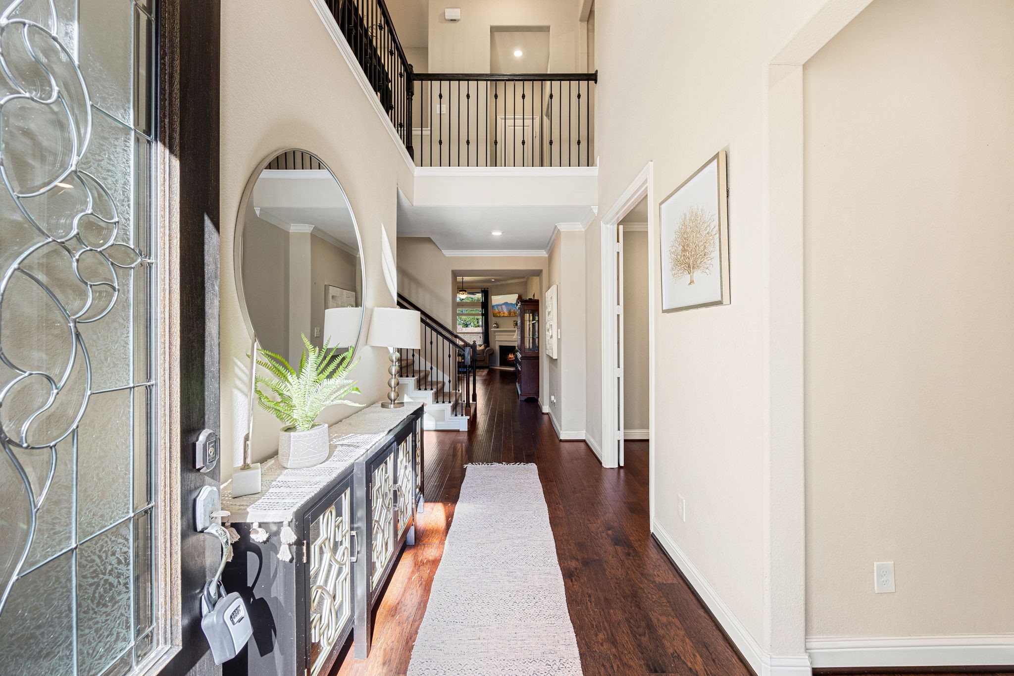 4225 Grand Oaks Wind Spring, TX 77386 - Photo 3 of 40 a view of a hallway with wooden floor and stairs