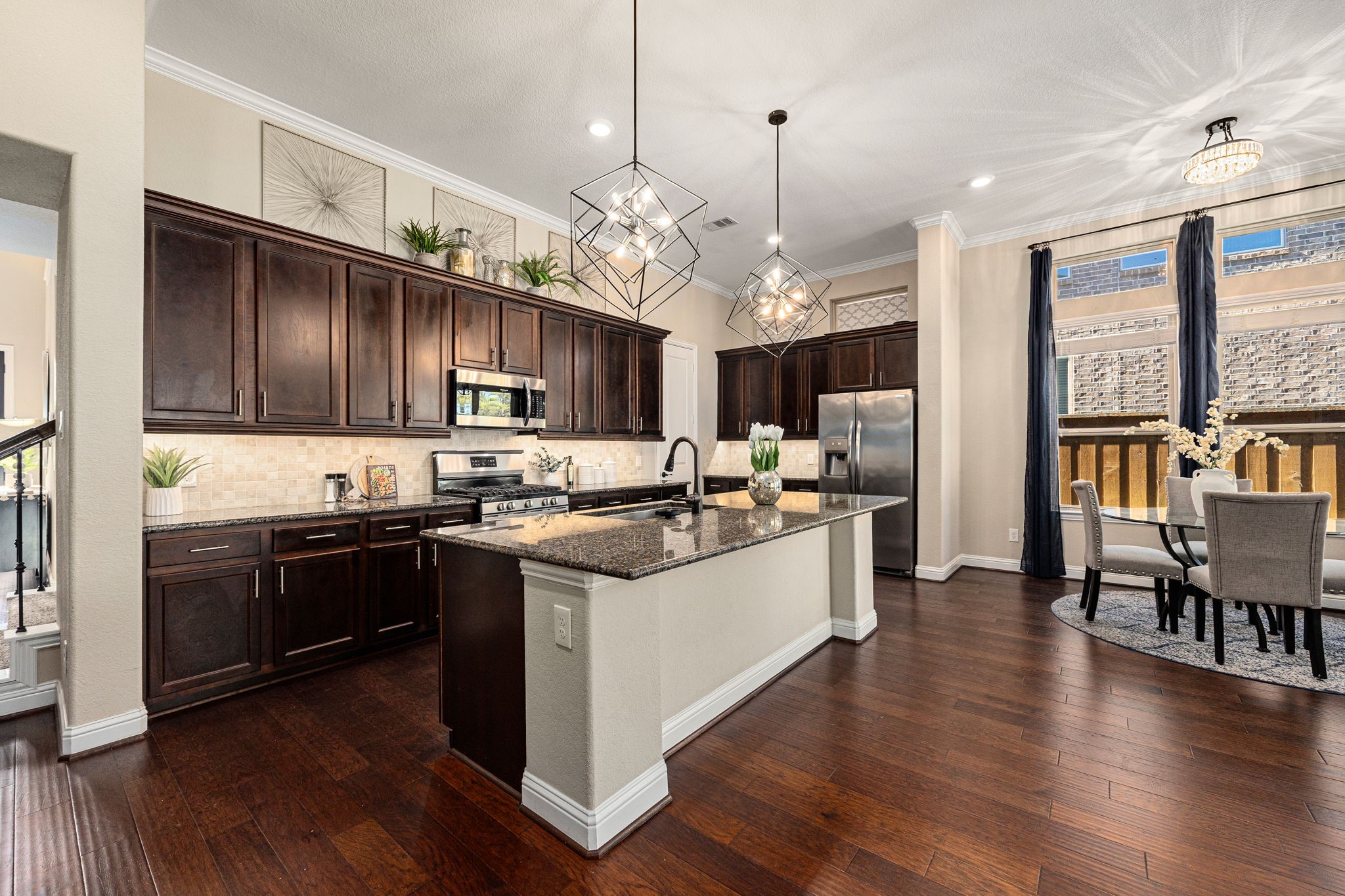 4225 Grand Oaks Wind Spring, TX 77386 - Photo 10 of 40 a kitchen with stainless steel appliances granite countertop wooden floors and view living room