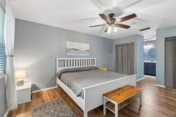 a bedroom with a bed and a chandelier