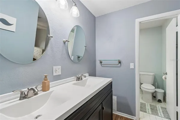 a white toilet sitting next to a bathroom sink