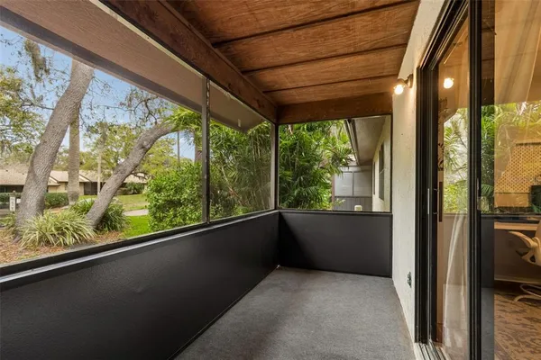 a view of a hallway with wooden floor and entryway