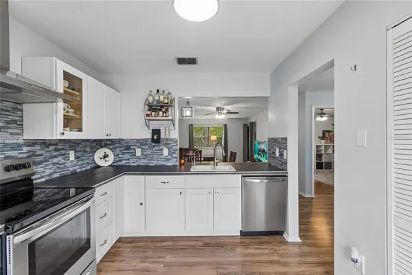 a kitchen with stainless steel appliances granite countertop a stove and a sink