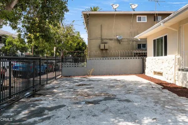 a view of a house with a wooden fence