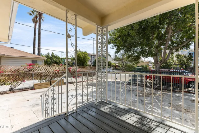 a view of balcony with a floor to ceiling window and wooden floor