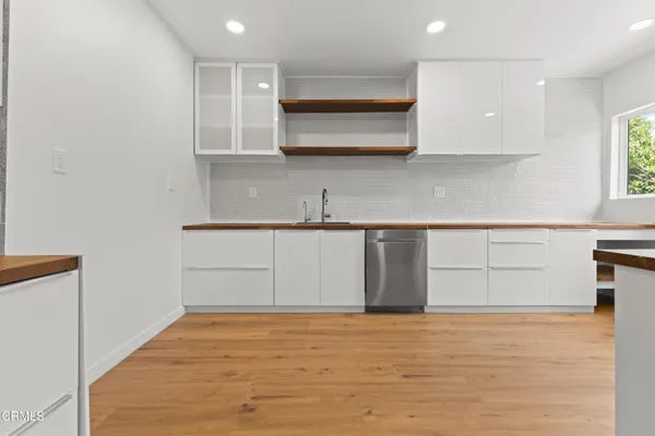 a kitchen with granite countertop a sink and cabinets