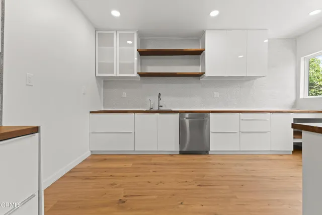 a kitchen with granite countertop a sink and cabinets
