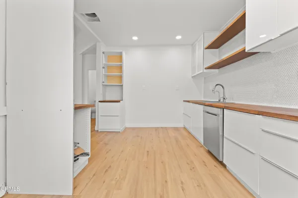 a hallway with a sink and a mirror