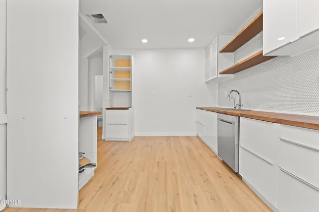 a hallway with a sink and a mirror