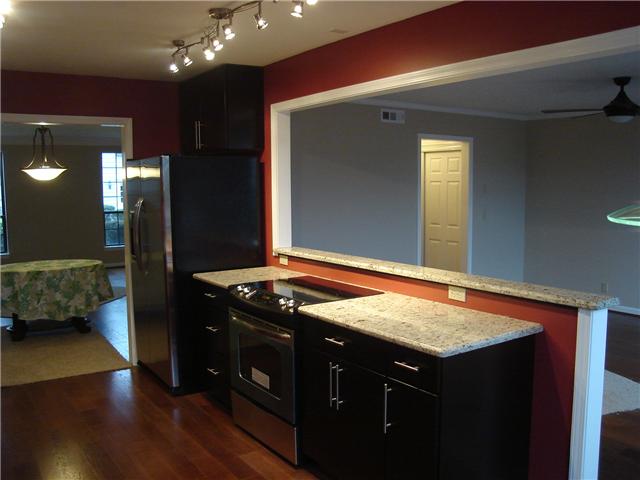 1284 Gen George Patton Road, Unit 1284 Nashville, TN 37221 - Photo 16 of 20 Kitchen has been opened to den. Half wall w/granite cap. Great smooth-top slide-in stove to make large opening into den.