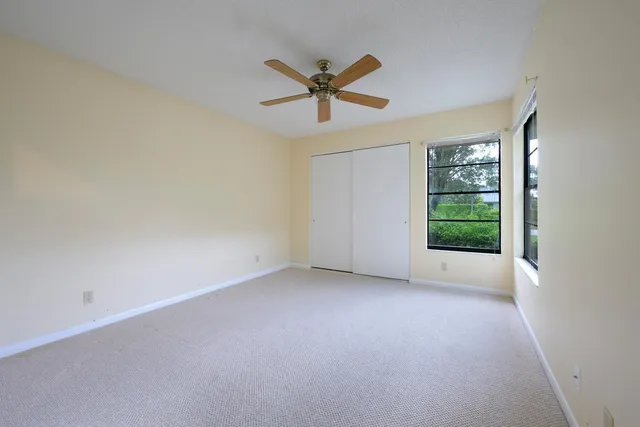 a view of a livingroom with a ceiling fan and window