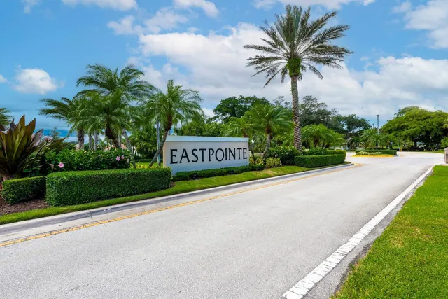 a sign on a street next to a yard