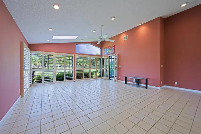 a view of an empty room with wooden floor and iron gate