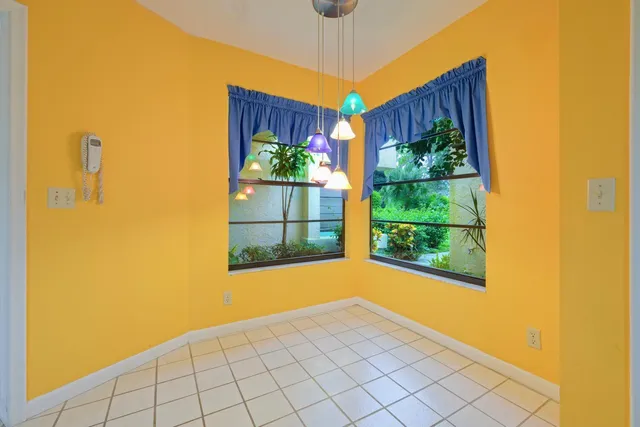 a view of a room with a window and wooden floor