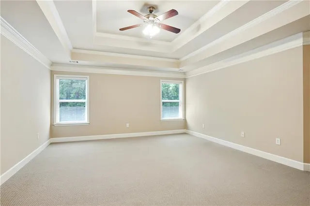 an empty room with a window and a ceiling fan