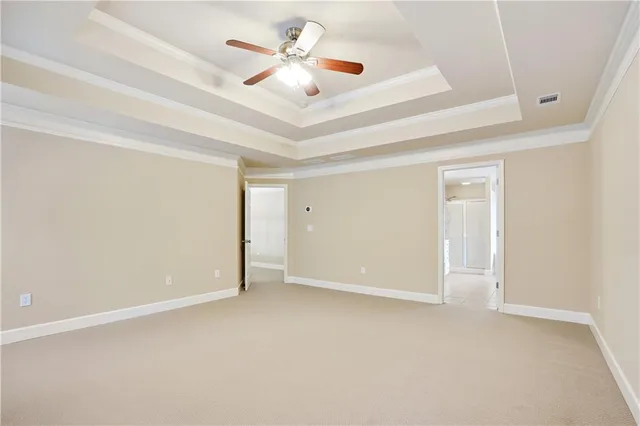 an empty room with a ceiling fan and a window