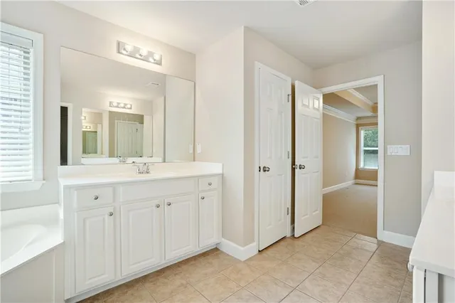 a spacious bathroom with 2 sink and a mirror