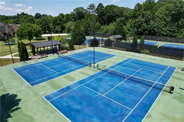 an aerial view of a house with garden space and swimming pool
