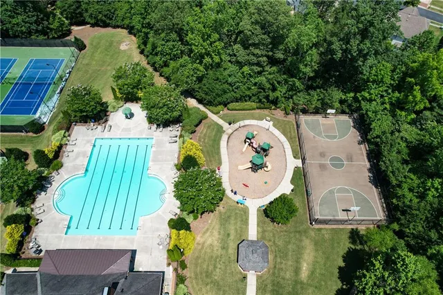 a view of house with wooden deck and garden