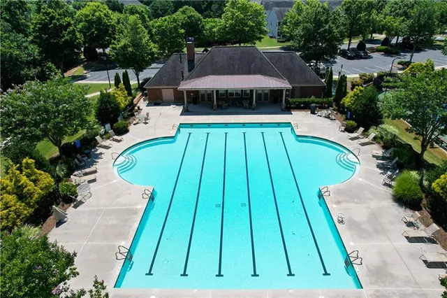 an aerial view of a house with a swimming pool