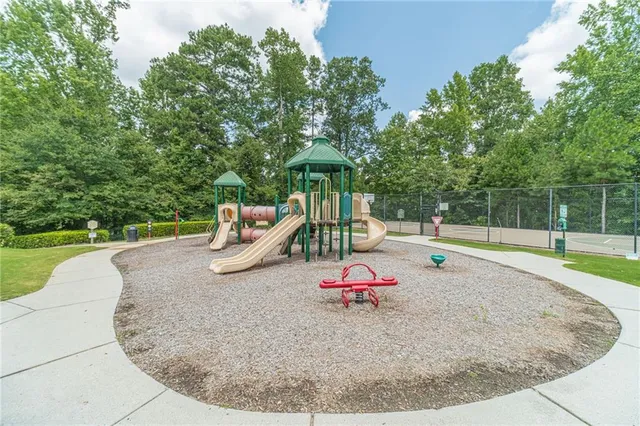a street sign on a sidewalk next to a road