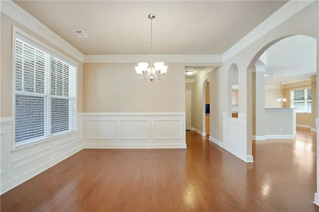 a view of a livingroom with wooden floor and a large window