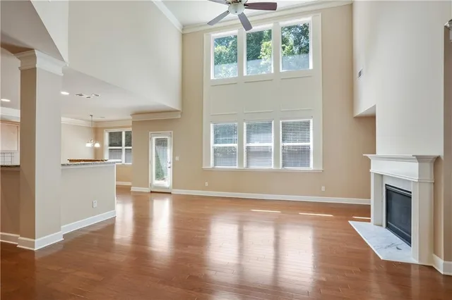a view of empty room with wooden floor and fireplace
