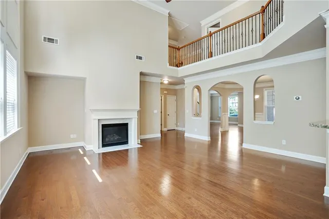 a view of a livingroom with wooden floor and a fireplace