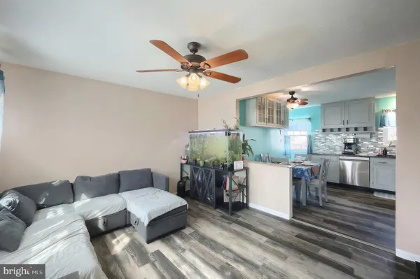 a living room with furniture and kitchen view