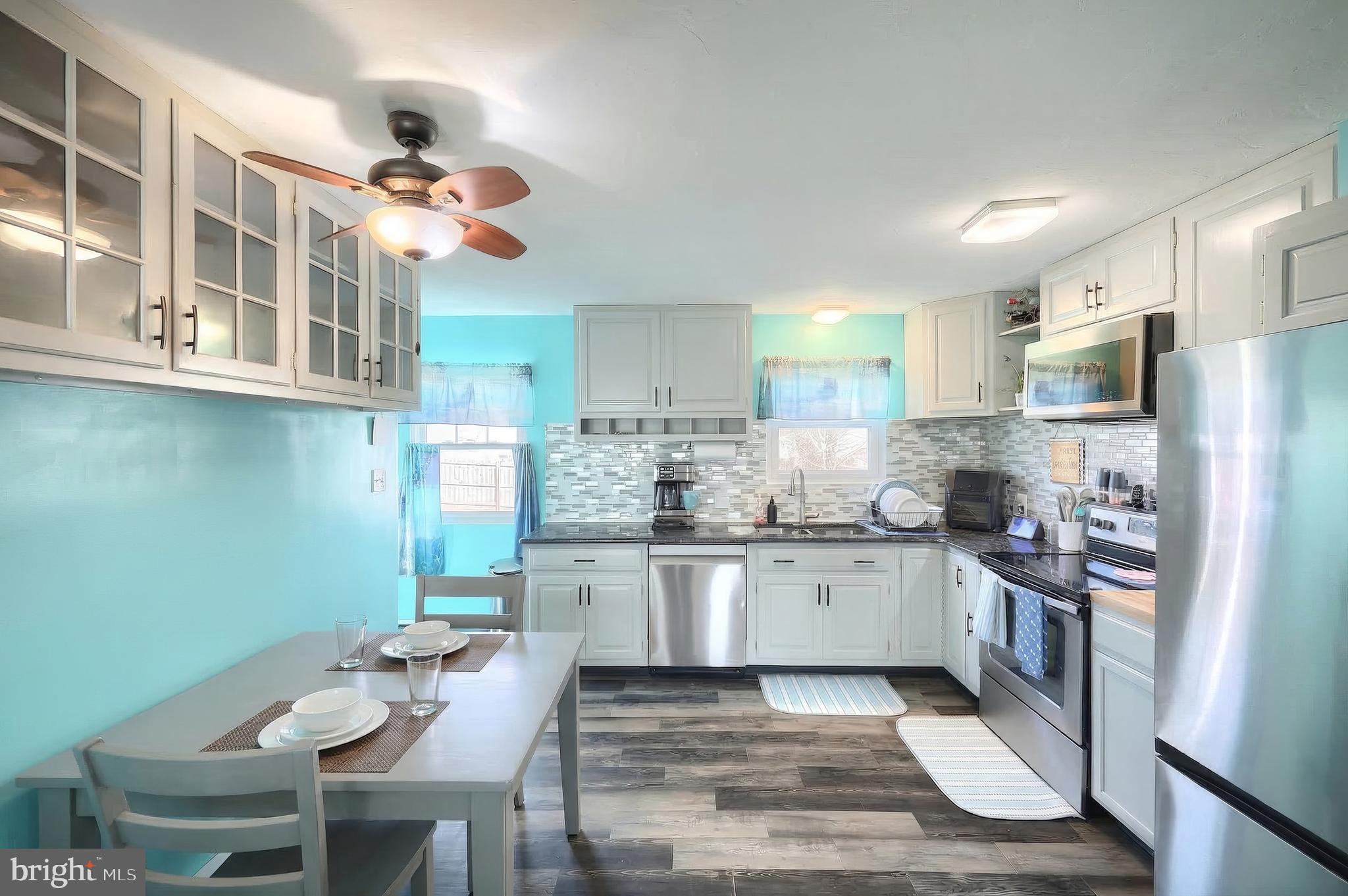 3551 Ruffed Grouse Drive Dover, PA 17315 - Photo 7 of 30 a kitchen with stainless steel appliances granite countertop a stove refrigerator a sink dishwasher and microwave oven