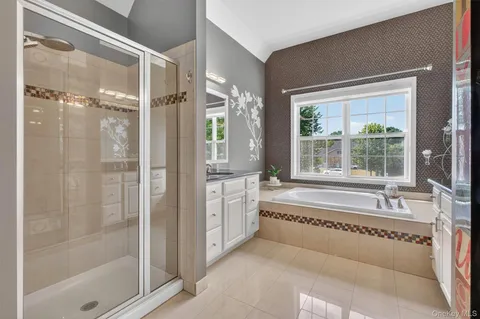 a spacious bathroom with a bathtub and a shower