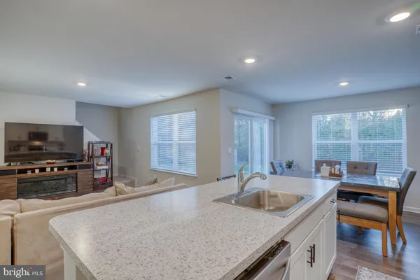 a kitchen with sink refrigerator and microwave