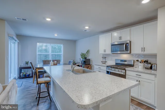a kitchen with sink a stove and cabinets