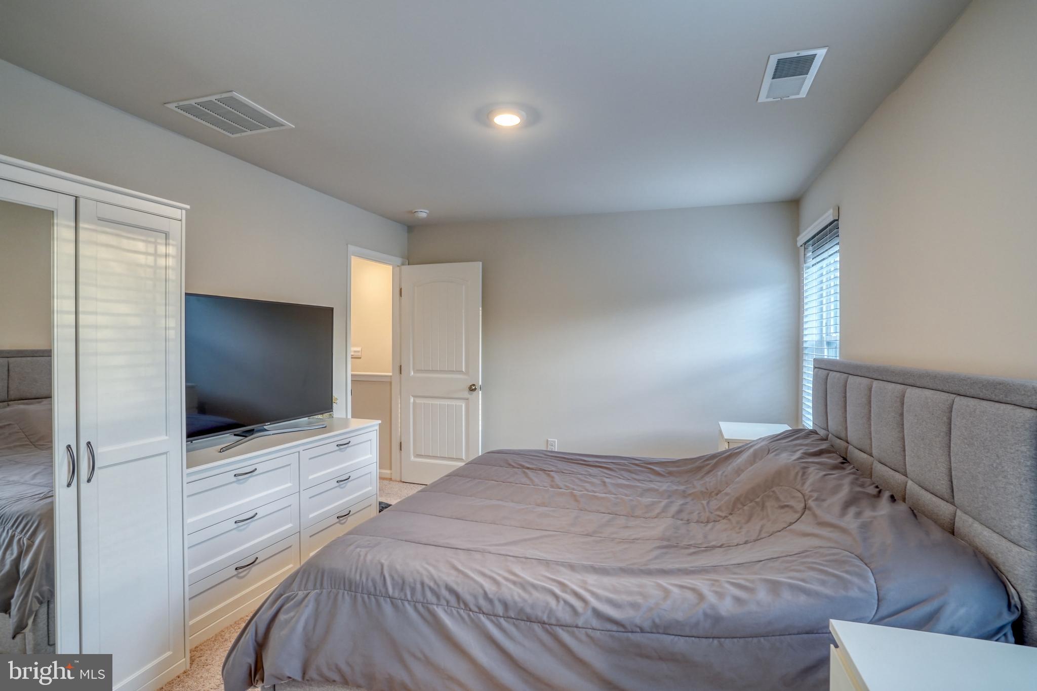 124 Currant Circle Magnolia, DE 19962 - Photo 38 of 45 a bedroom with a bed and a flat screen tv