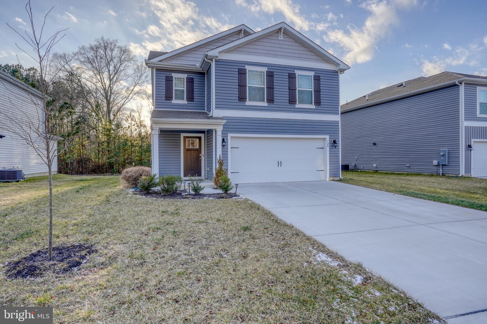 124 Currant Circle Magnolia, DE 19962 - Photo 4 of 45 a front view of a house with a yard and garage