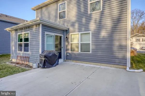 a view of a house with a small yard and a large window