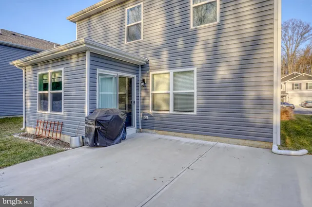 a view of a house with a small yard and a large window