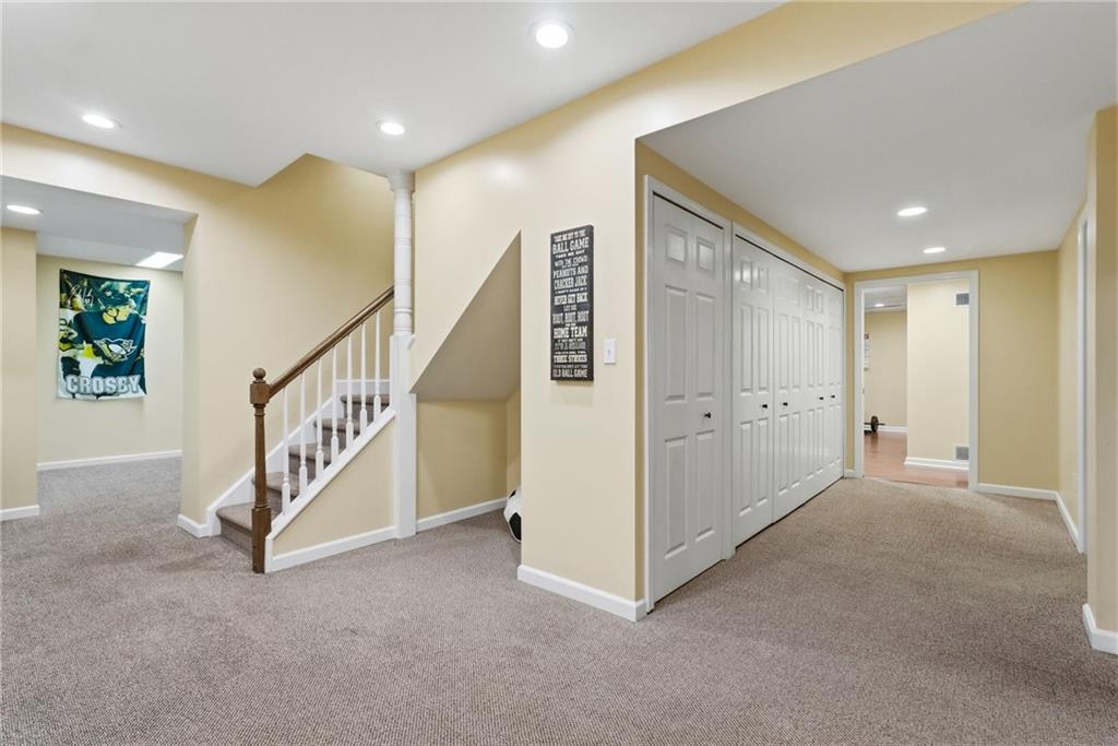 900 Settlers Ridge Road Pittsburgh, PA 15238 - Photo 33 of 50 The expansive lower-level landing serves as a central hub connecting the game room, media room, fitness area, kitchenette, fifth bedroom, wine storage, and abundant general storage space.