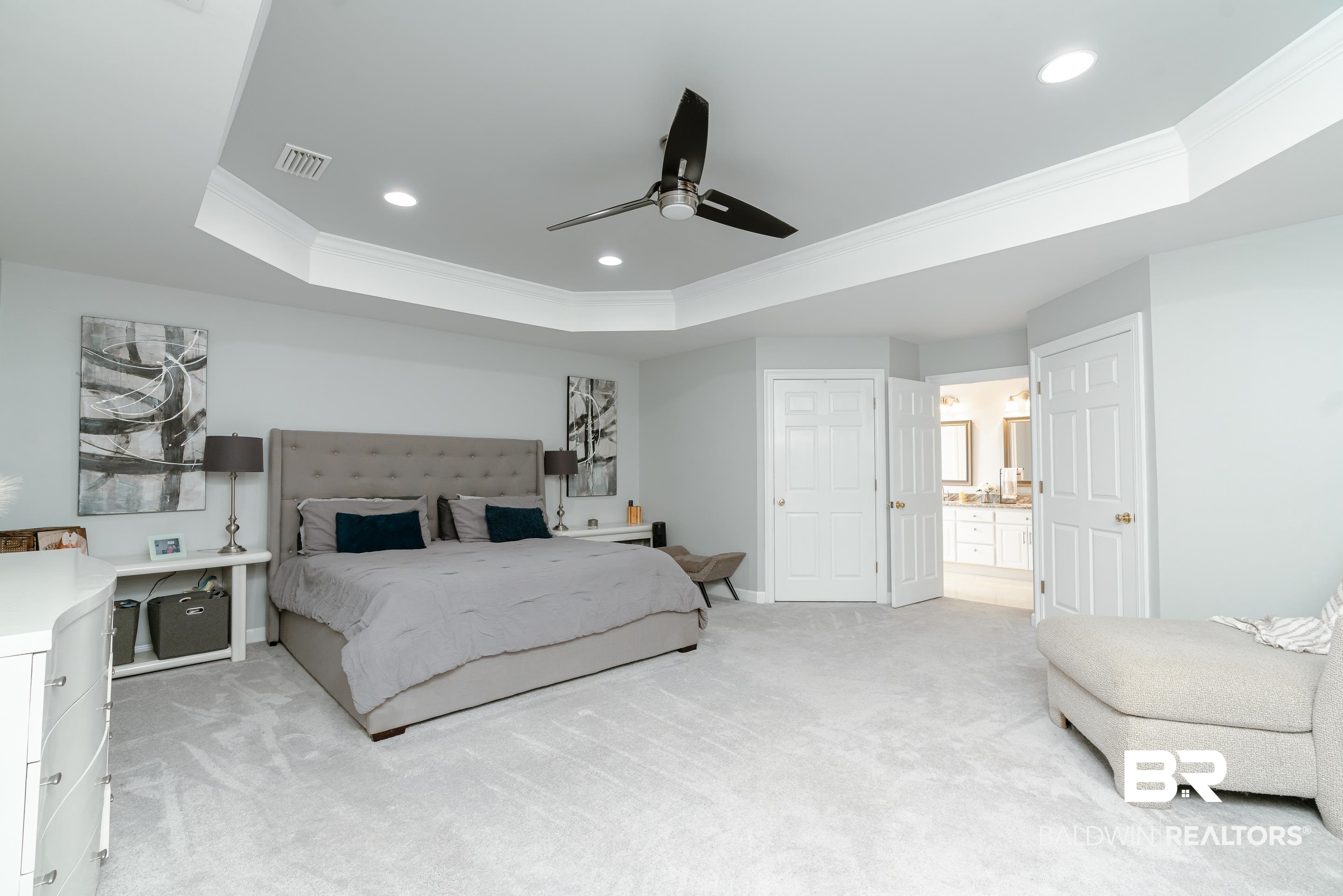 9477 Deerfield Drive Irvington, AL 36544 - Photo 19 of 58 Carpeted bedroom with ceiling fan, a raised ceiling, crown molding, and connected bathroom
