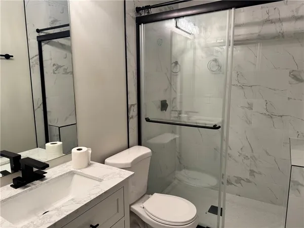 a bathroom with a sink toilet and shower