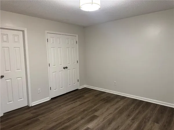 a view of room with wooden floor