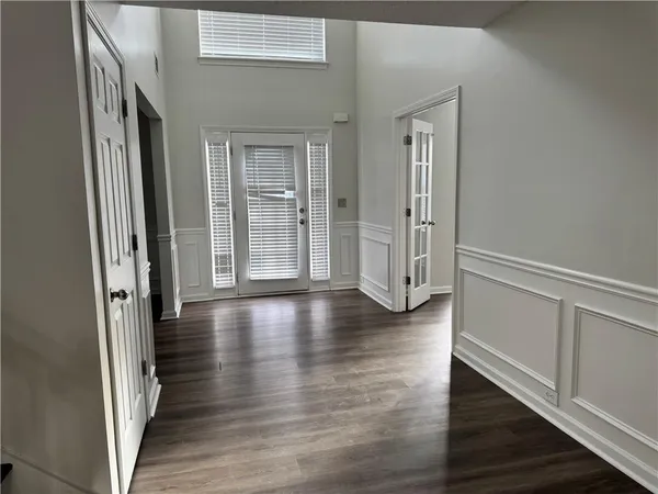 a view of a hallway with wooden floor and staircase
