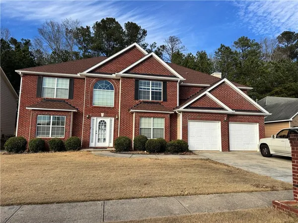 a front view of a house with a yard
