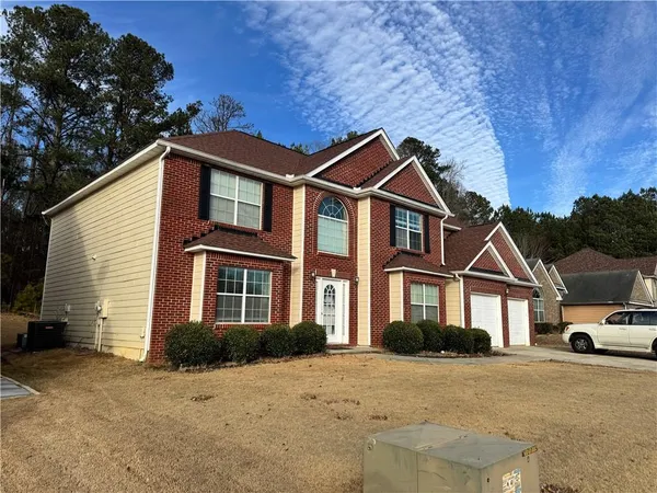 a front view of a house with a yard