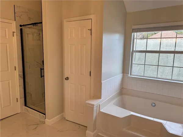 a bathroom with a tub and shower